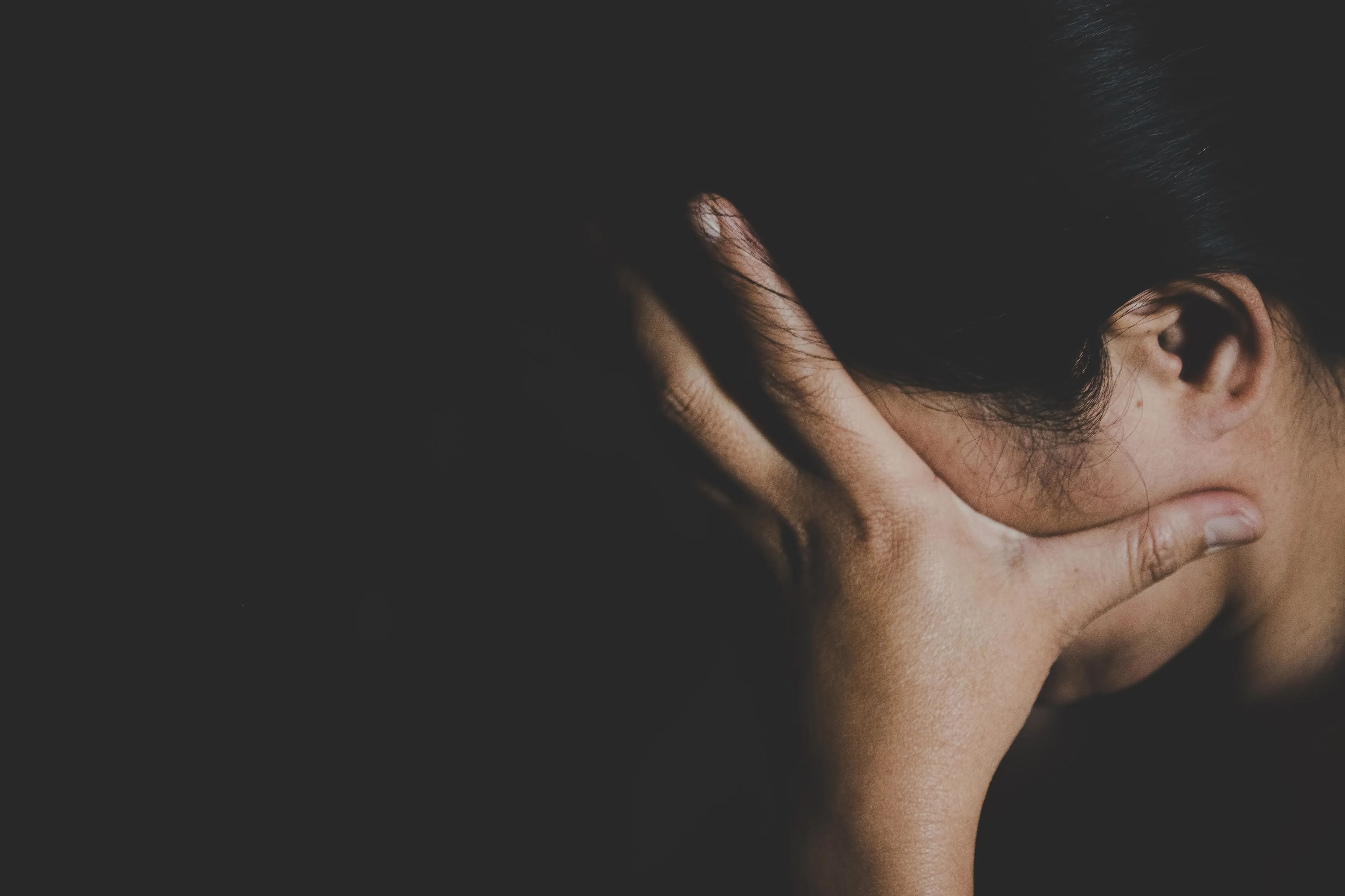 woman with a hand on her face in despair